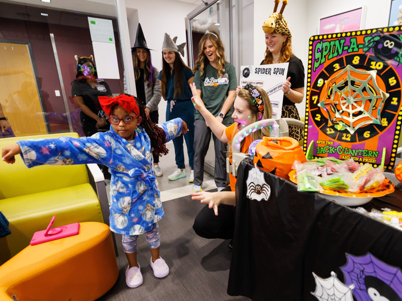 Janelle Johnson of New Orleans shows her scarecrow stance during Halloween games Monday morning at the Kathy and Joe Sanderson Tower at Children's of Mississippi.